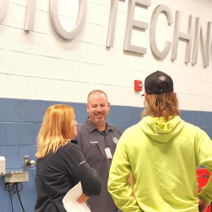 Instructor speaking with student and parent