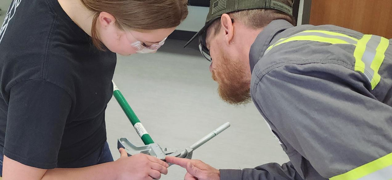 Student learning to bend conduit