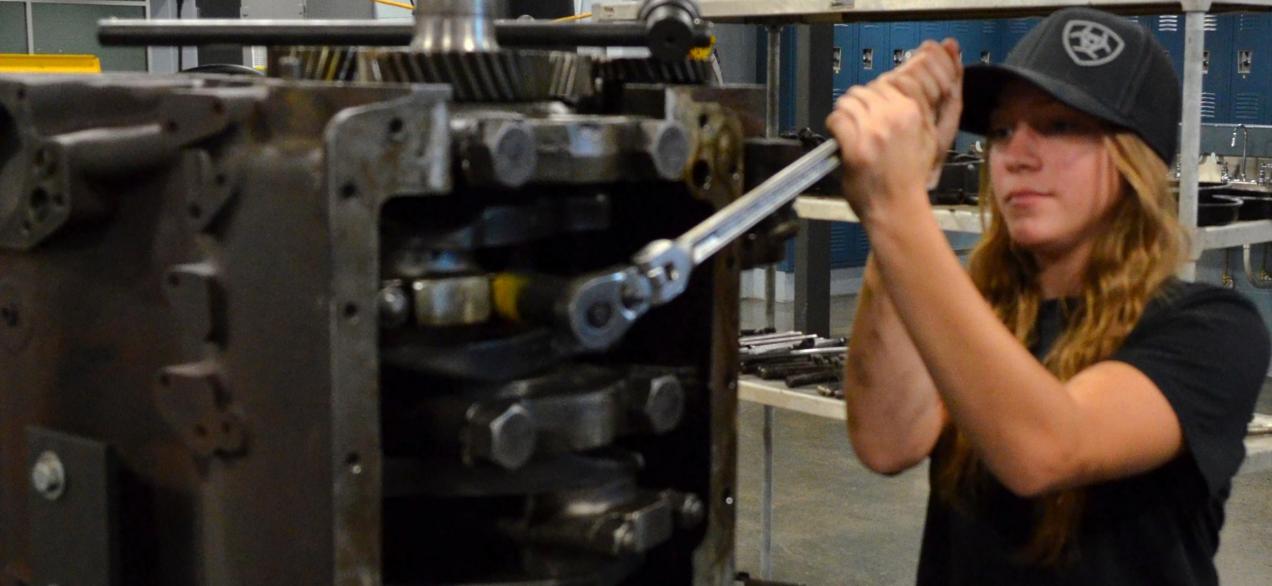 Image of a student tightening bolts on a truck part