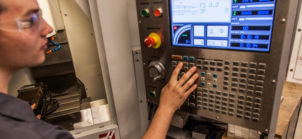 Image of student programming a CNC machine