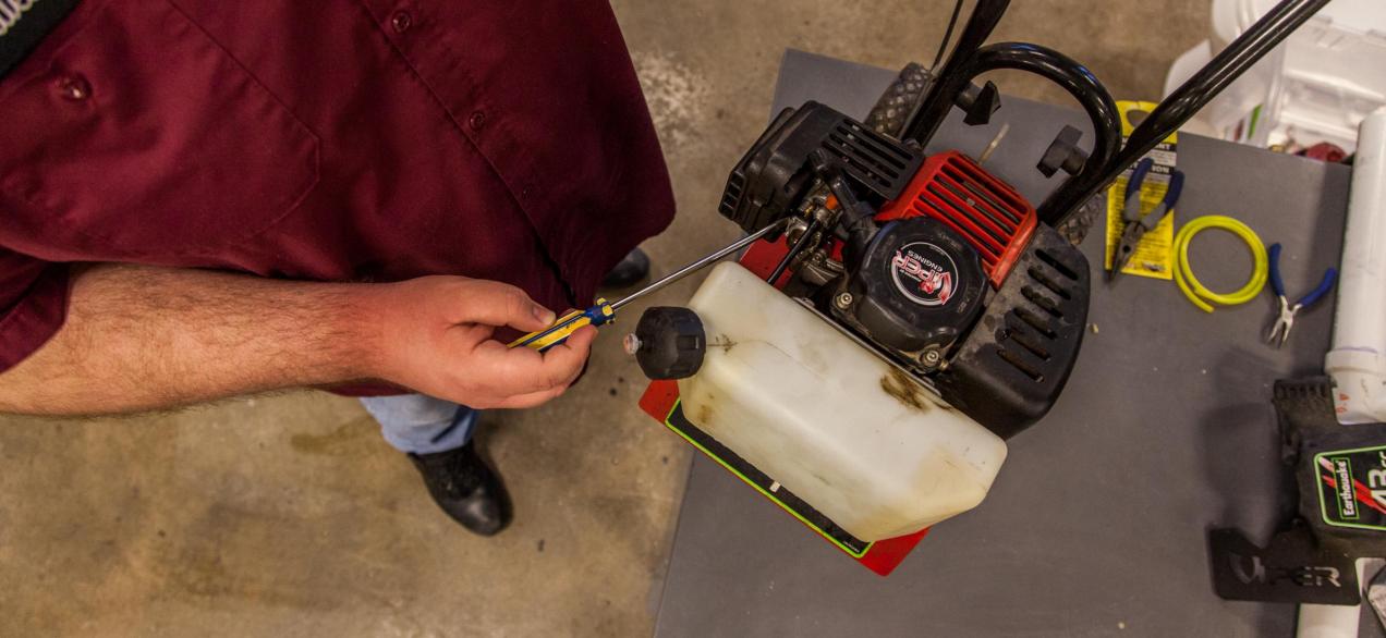 Image of student working on small engine 