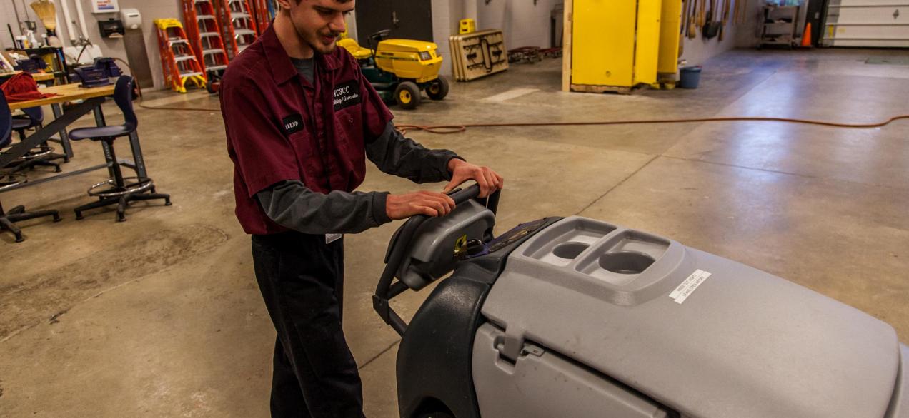 Image of student using machine to clean floors