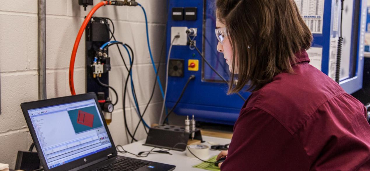 Image of female student working on designing a project on a labtop