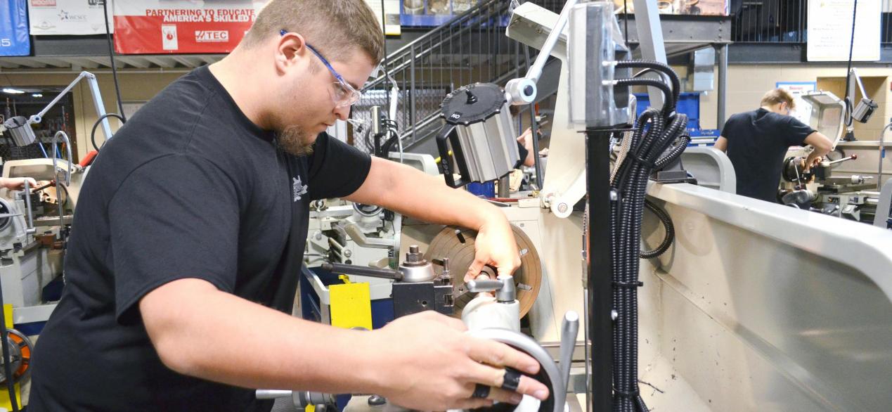 Student turning a part on a lathe