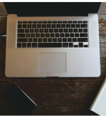 image of a laptop computer, notepad, and pen